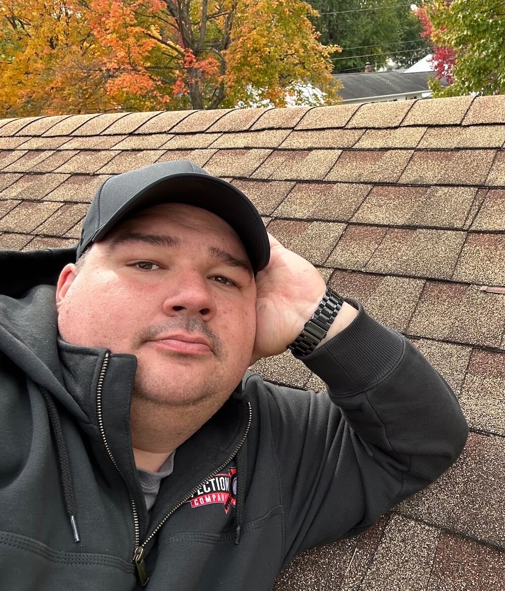 Ryan Hosch on a roof during inspection